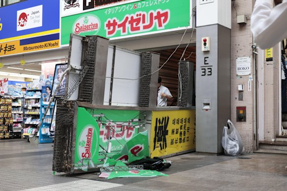 A store sign of a restaurant is seen fallen on the ground after an earthquake in Kumamoto in the Kyushu island, southern Japan,