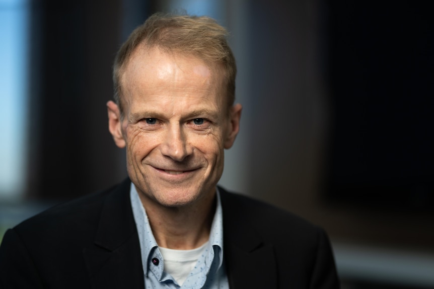 Portrait head and shoulders Richard Scolyer slight smile wearing a suit