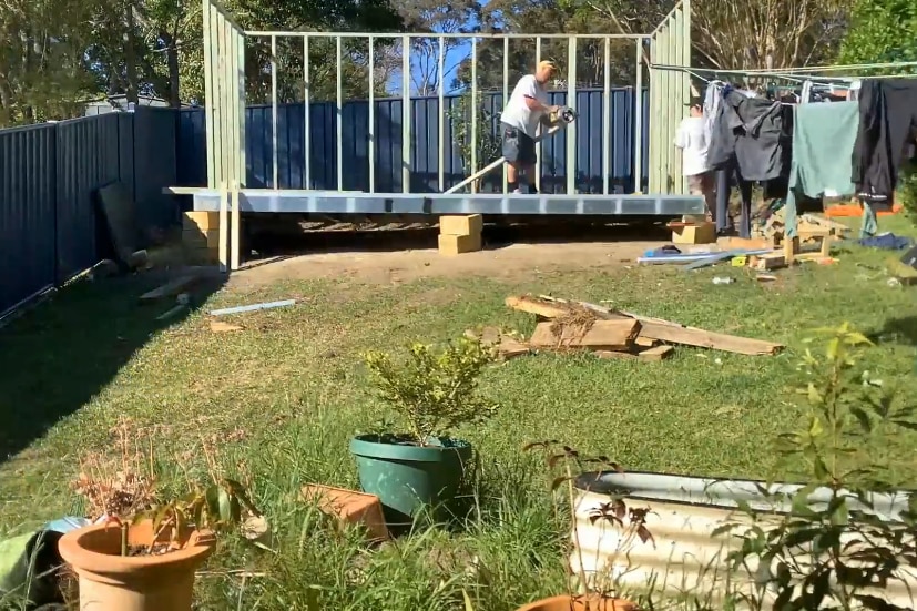 Steve Preston building a shed in Chris Blewitt's backyard.