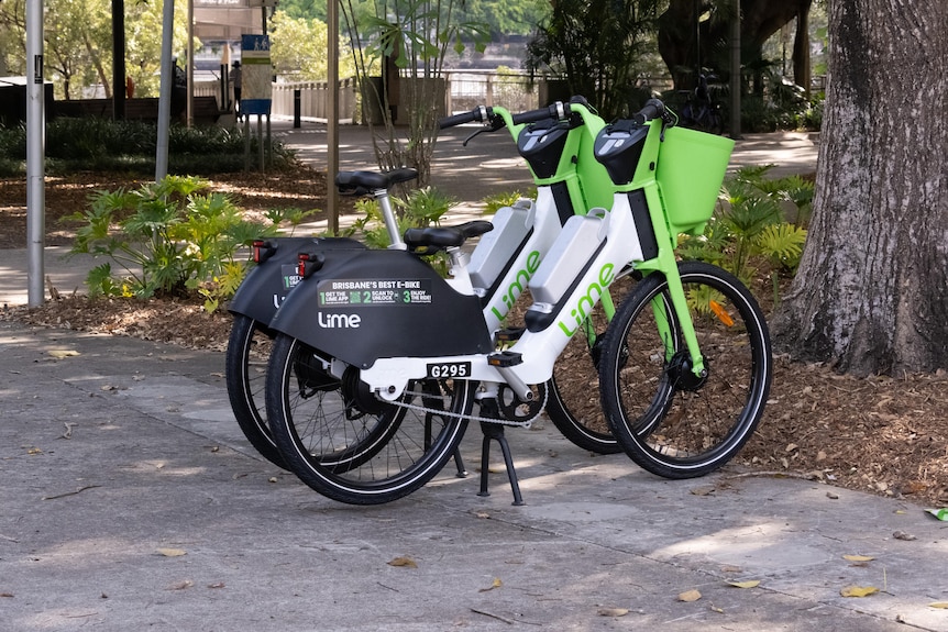 Two e-bicycles parked on an urban street