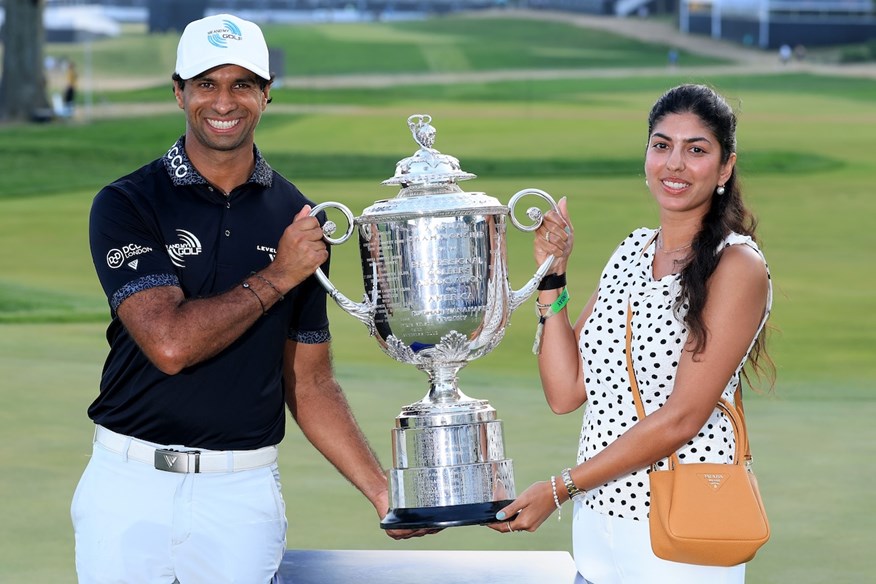 Aaron Rai and his wife, Gaurika Bishnoi, pose with the PGA Championship trophy after the Englishman's win at Aronimink.