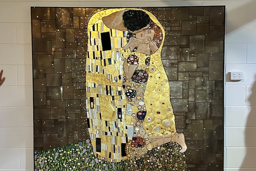 Mosaic version of Klimt painting The Kiss with gold leaf.