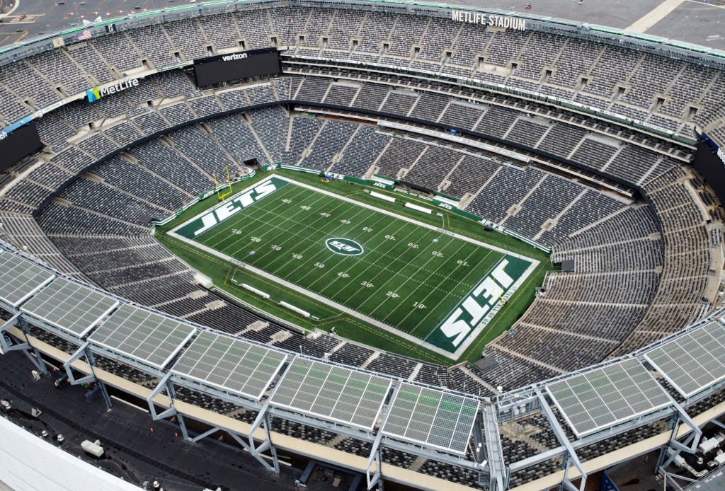 Aerial view of MetLife Stadium, home to the New York Jets and Giants, showing the empty stands and the "JETS" logo on the football field.