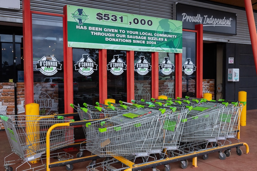 Shopping trolleys at the entrance to a supermarket.