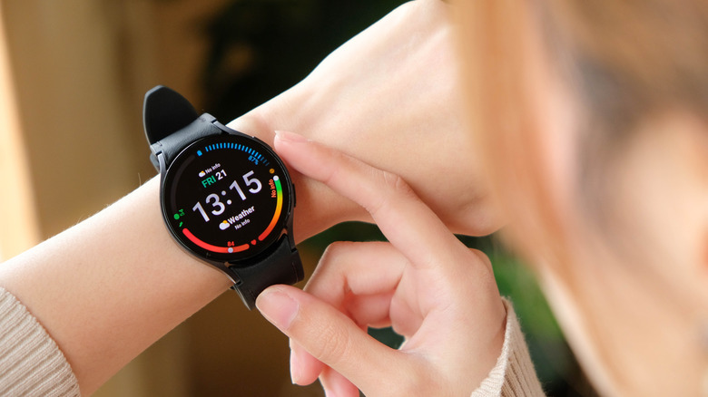 An individual looks at the screen of their Samsung Galaxy Watch
