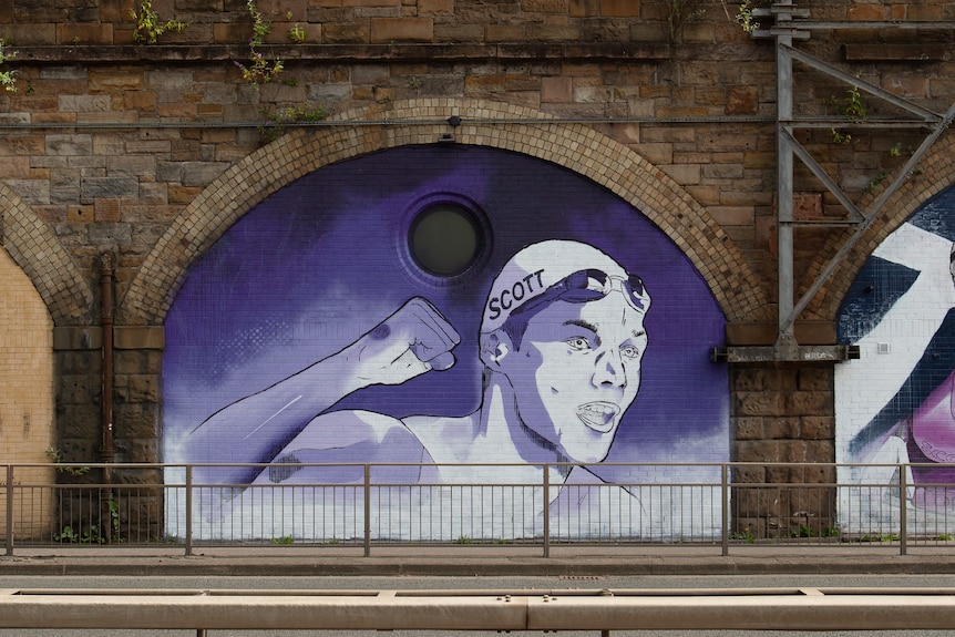 A mural of Scottish swimmer Duncan Scott on the side of an expressway in Glasgow.