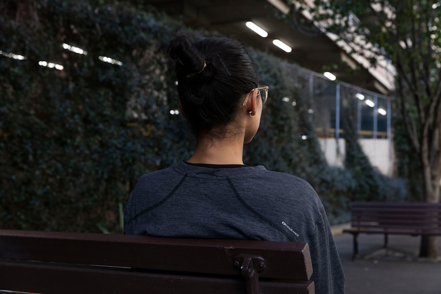 An anonymous woman on a bench in Sydney