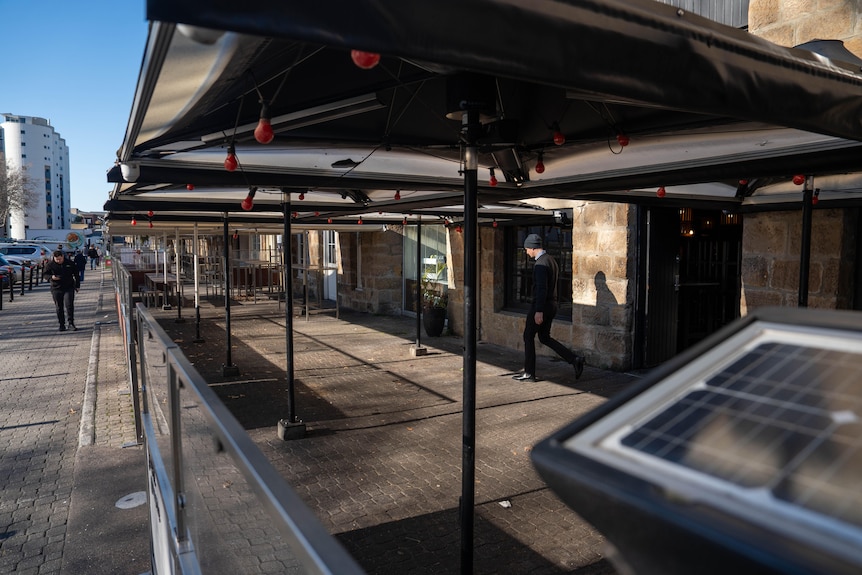 Empty outdoor-bar areas line the Salamanca strip, their tables and chairs packed away.