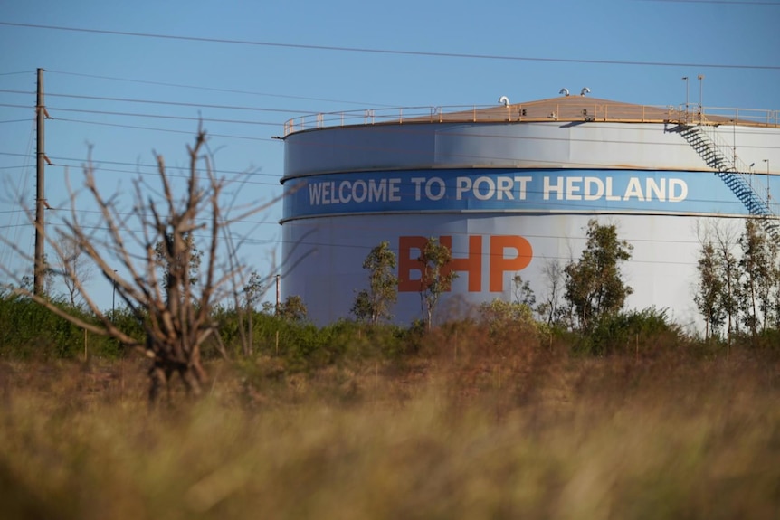 A large silo tank with BHP and 'welcome to Port Hedland' written on it