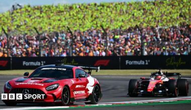 The safety car with eventual race winner Charles Leclerc, of Ferrari, immediately behind in the closing stages of the British Grand Prix