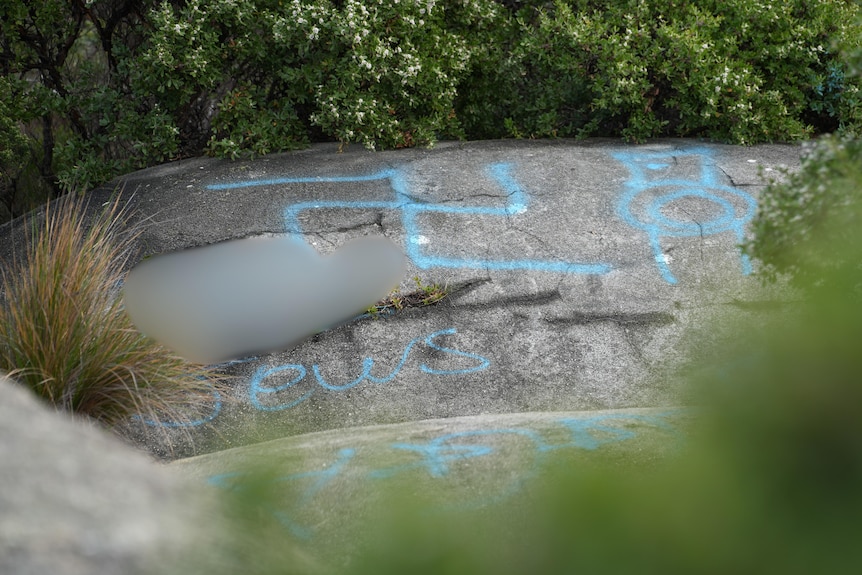 Offensive graffiti sprayed onto rocks near the complex.
