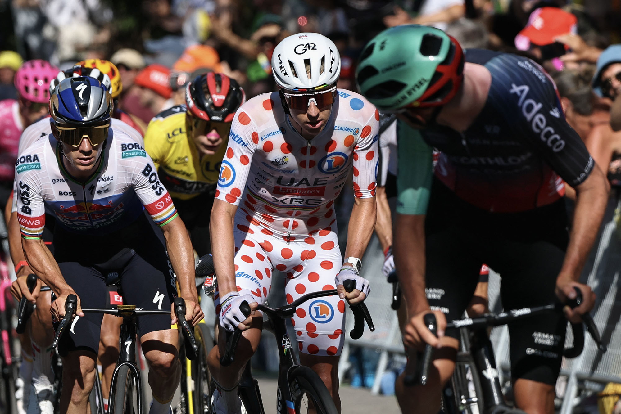 Evenepoel racing alongside Pogačar, in polka dots, on stage 2