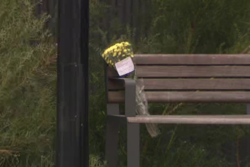 Flowers were left by mourners on a park bench in Craigieburn
