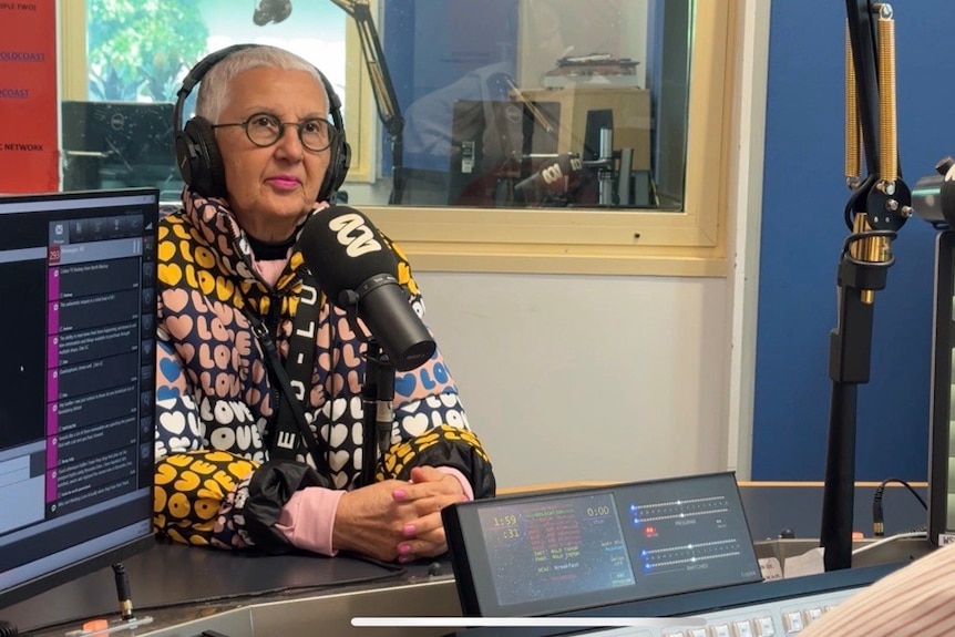 Woman with microphone in a radio studio