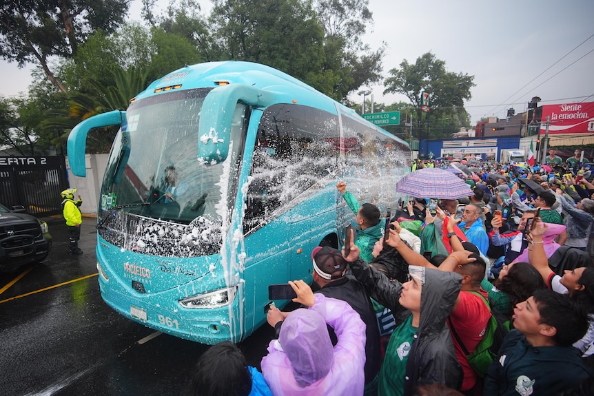 England's team bus is soaked in liquid by Mexico fans upon arrival at the stadium