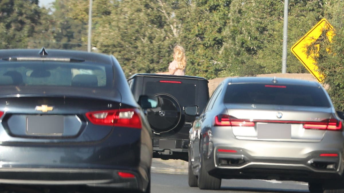 Britney Spears sticking her head out of the sunroof as she is driven on the 101 freeway.