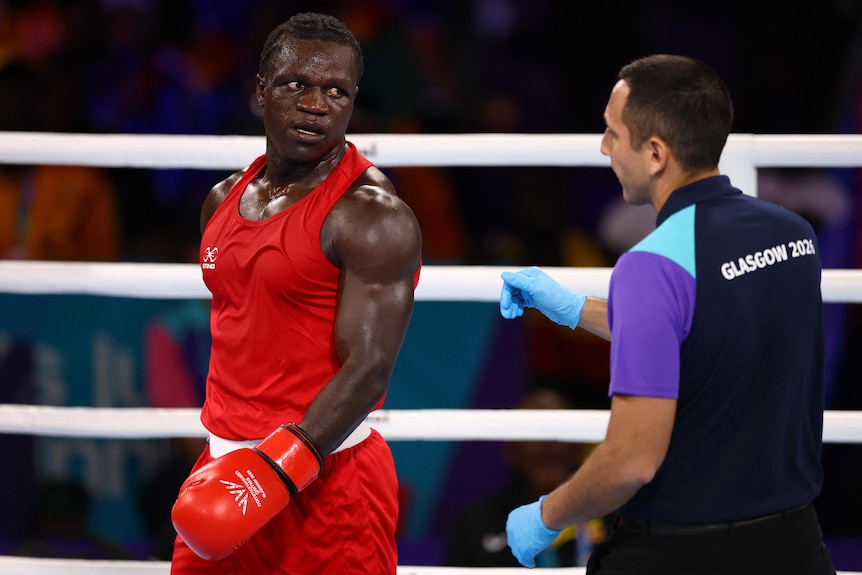 Aziz Abdul looks unhappily at the referee as he is disqualified during his Commonwealth Games fight.