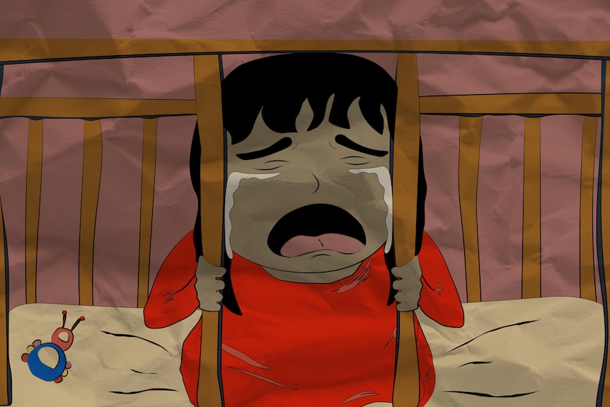 Baby cries through cot railing.