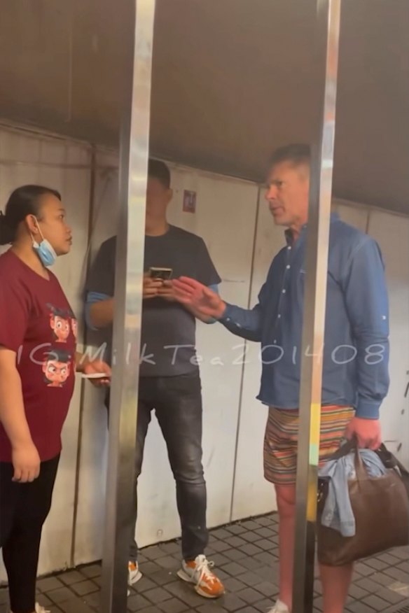 Screen grab from social media in Hong Kong of Monkivitch (right) being pursued by restaurant staff over unpaid bills.