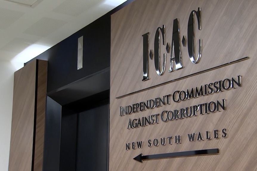 A sign for the ICAC outside a closed elevator.