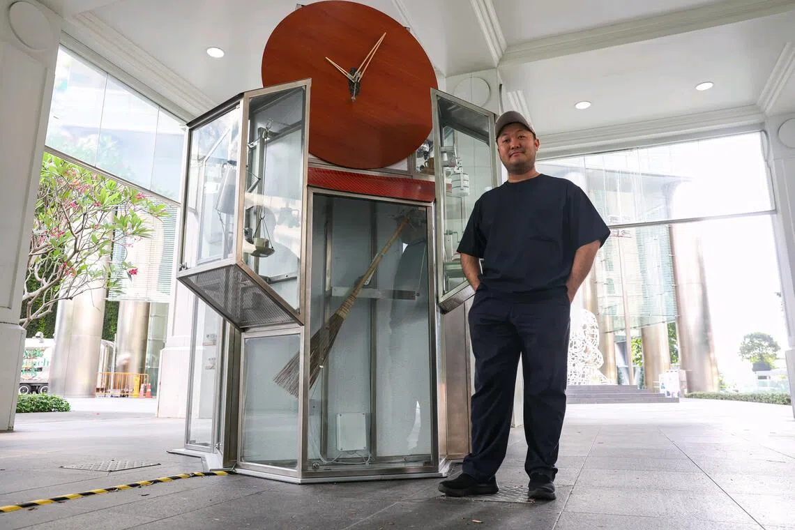 Artist Yang Jie with his kinetic sculpture, Clock of the Everyday, at Raffles Place on July 1, 2026. The artwork is part of the Singapore Art Museum's first public art trail in Singapore's Central Business District. ST PHOTO: BRIAN TEO