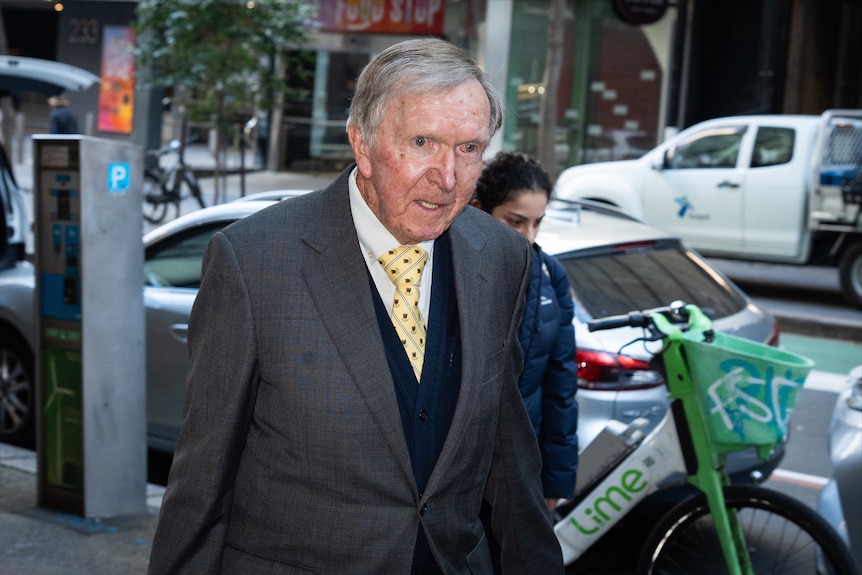Michael O'Hara walking in suit