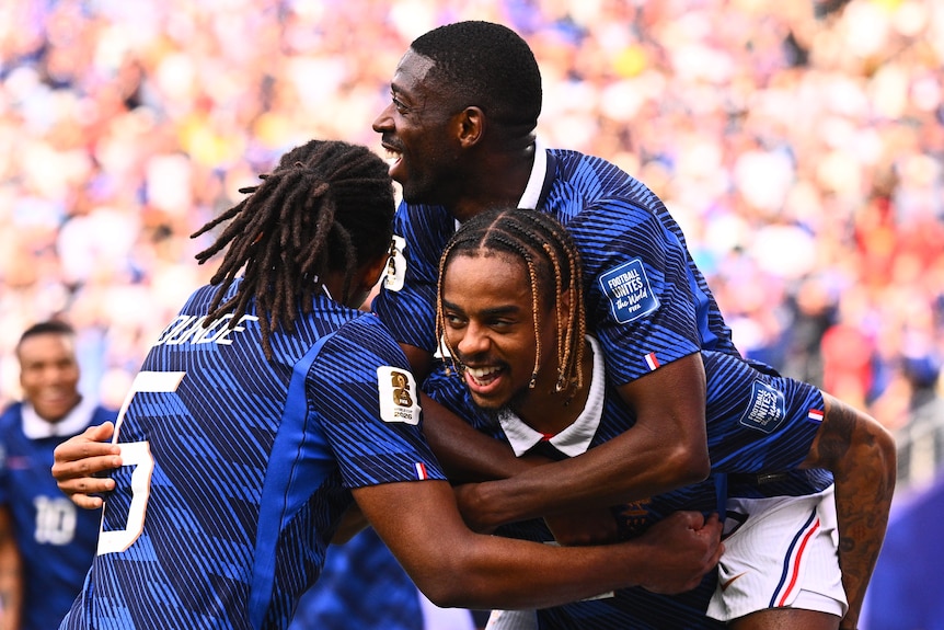 France players converge to celebrate a Bradley Barcola goal