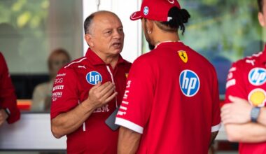 Vasseur looking serious in conversation with Hamilton, who has back to the camera