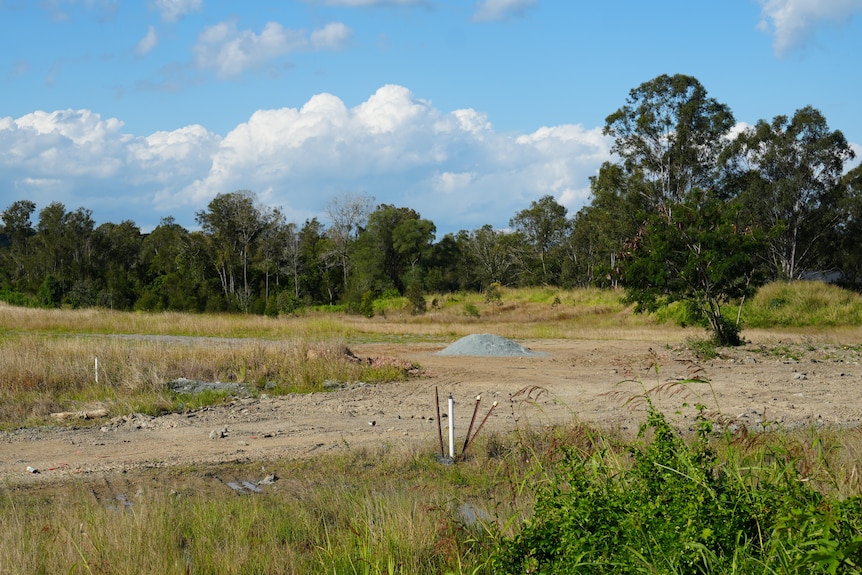a mound of dirt in a field which is set to be the moreton bay indoor sports centre