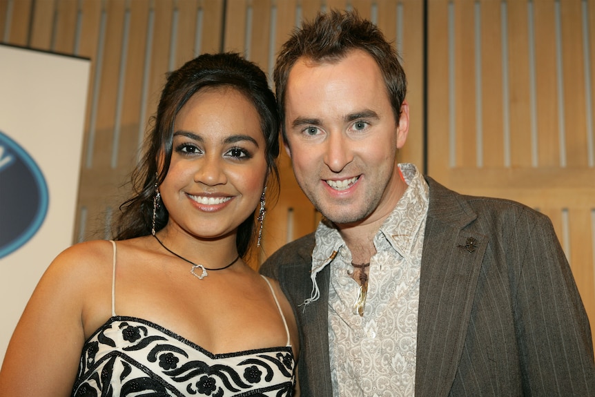 A very young Jess Mauboy stands smiling next to Damien Leith