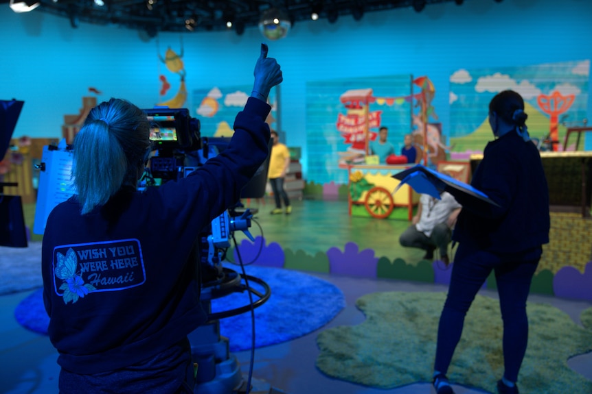 Play School behind the scenes. Camera operator facing away gives a thumbs up
