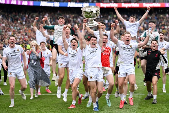 Mayo captain Jack Coyne and his teammates celebrate with the Sam Maguire Cup following All-Ireland championship final.