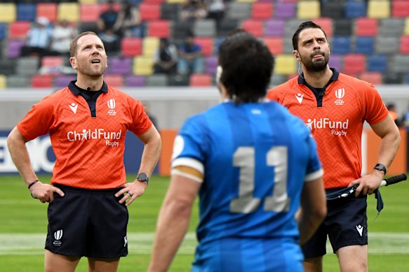 Angus Gardner (left) looks on as the TMO reviews a decision in the England-Argentina clash on the big screen.