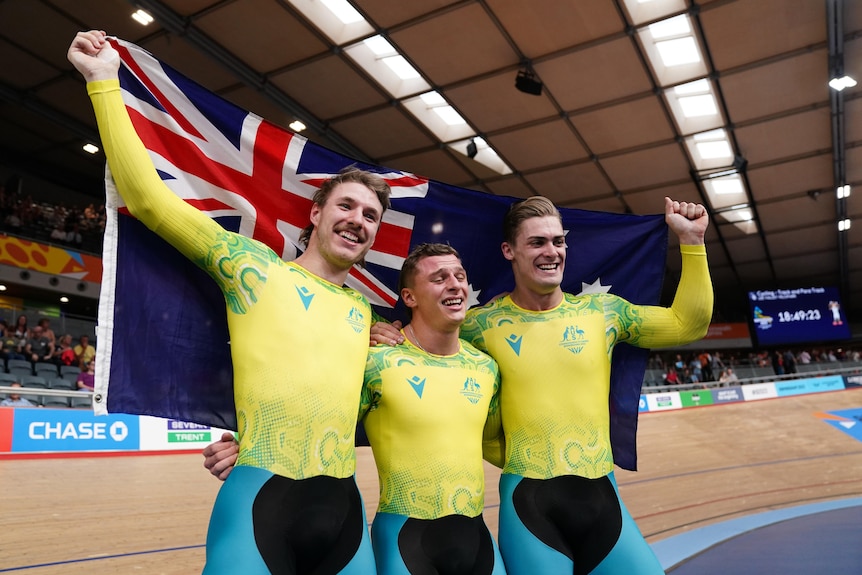 Leigh Hoffman, Matthew Richardson and Matthew Glaetzer holds the Australian flag.