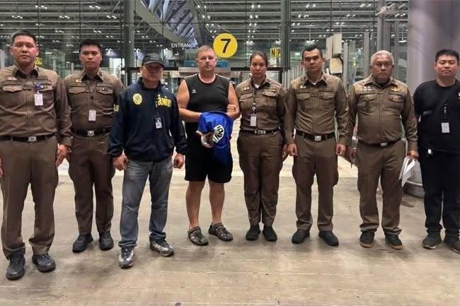Police parade Mr Carman after his arrest at Bangkok airport. Picture: The Pattaya News
