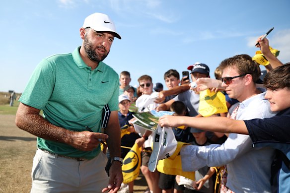 Scottie Scheffler of the United States signs autographs for fans ahead of The Open Championship at Royal Birkdale. 