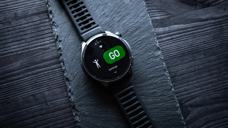 An Amazfit Balance 2 smartwatch on a dark surface.