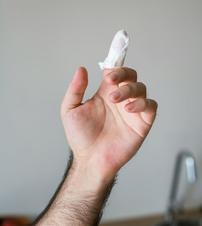 A hand with a bandaged finger, possibly an injury that might lead to an encounter with ER staff and ridiculous patients.