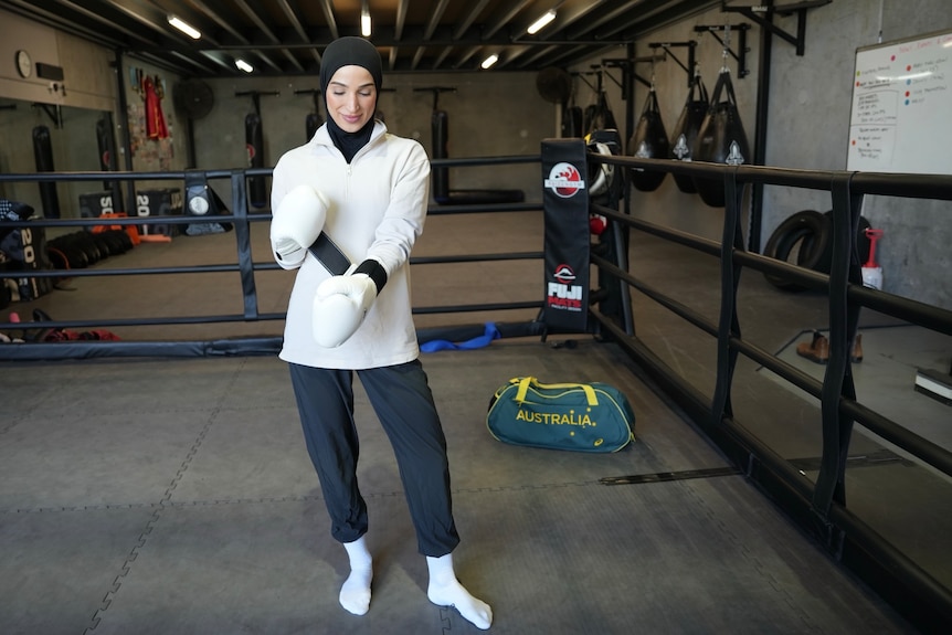 Tina Rahimi looks at her gloves ahead of training.