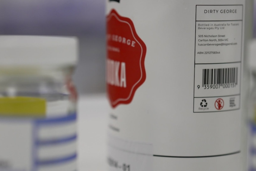 The back of a vodka bottle sitting on a table.
