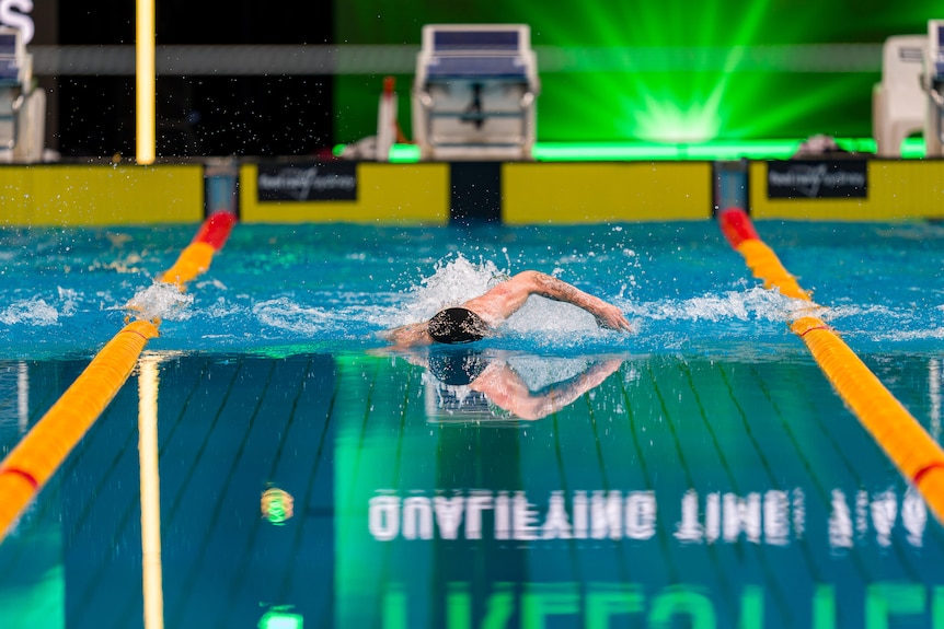 Sam Short, unidentifiable, swims towards the camera at the Australian Swimming Trials.