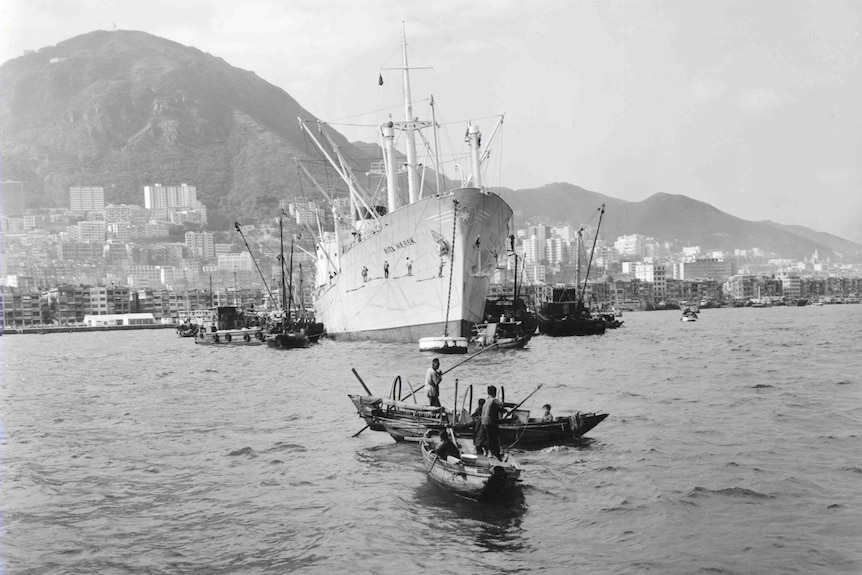 A black and white photo of a cargo shop in Hong Kong hardbour in the 1960s.