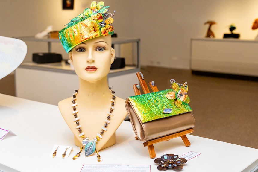 A mannequin bust adorned with jewellery.