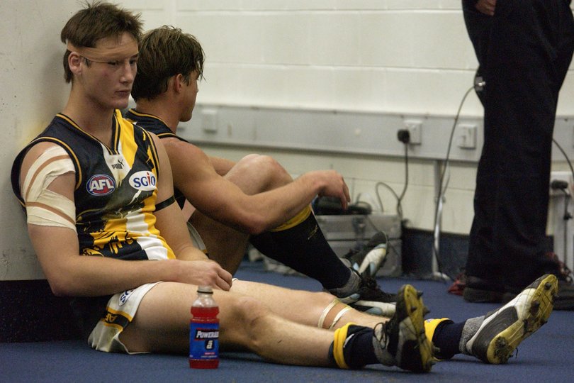 Adam Hunter of the Eagles sits dejected in the change rooms after losing the AFL First Elimination Final in 2002.