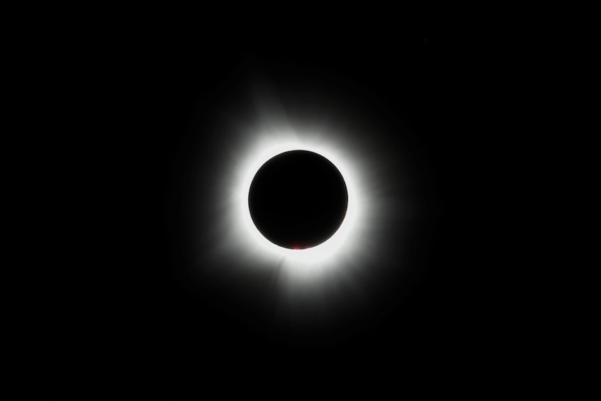 A ring of light around a black orb.