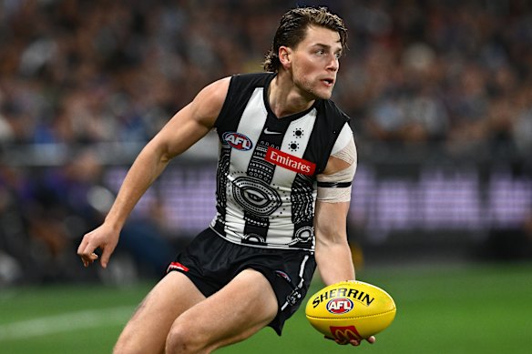 Patrick Lipinski of the Magpies handballs.