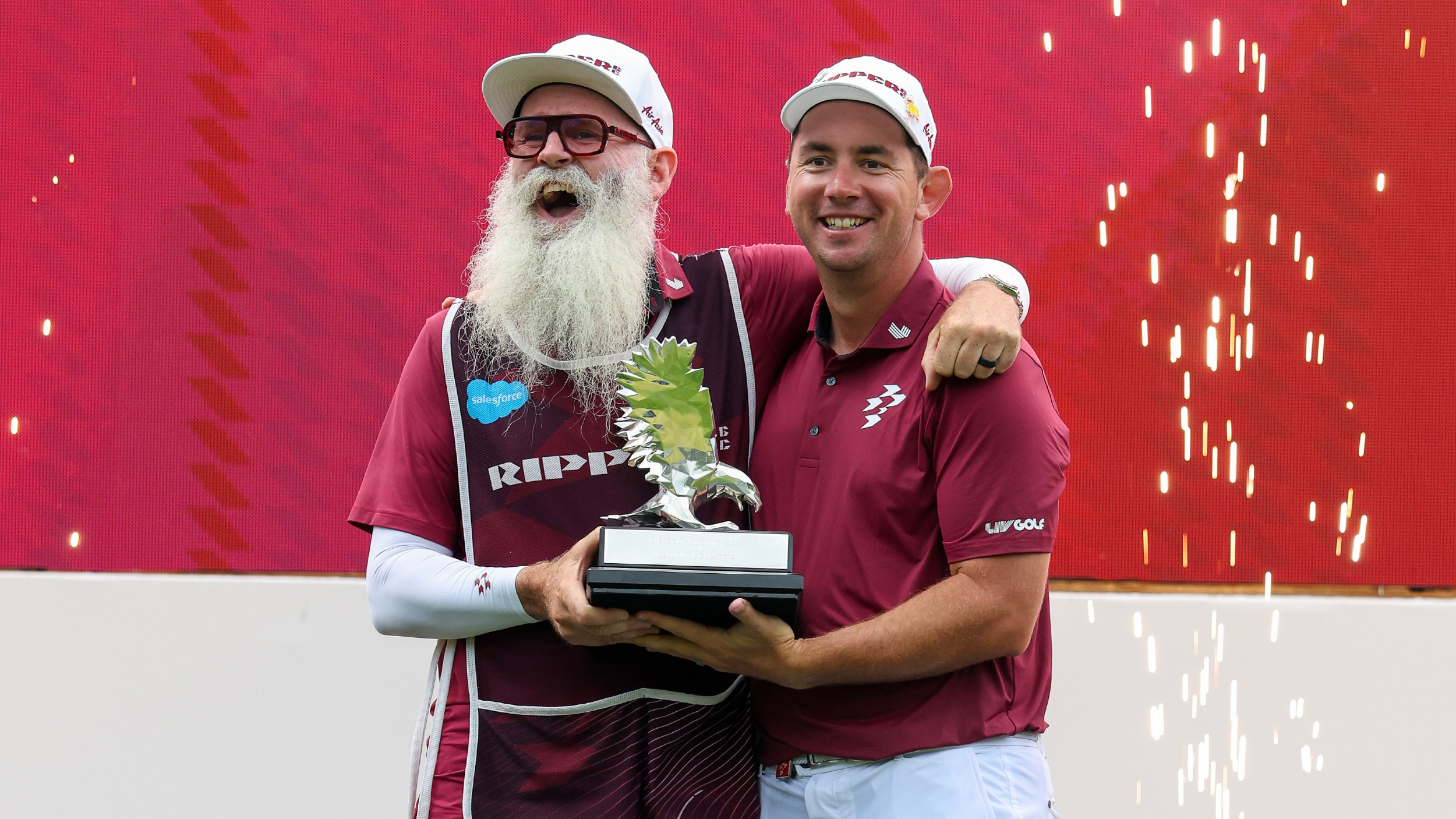Lucas Herbert with his caddie holding the LIV Golf Virginia trophy