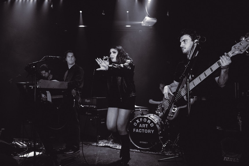 A black and white photo of a young band performing.