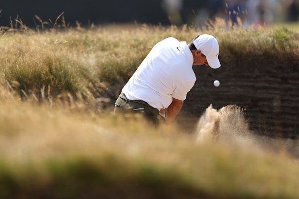 Rory McIlroy plays from a bunker in the third rounds of the British Open.