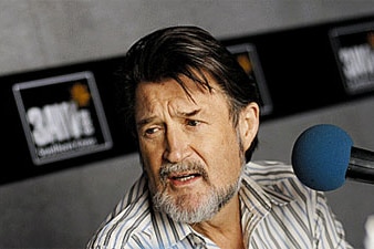 Hinch in front of a microphone.